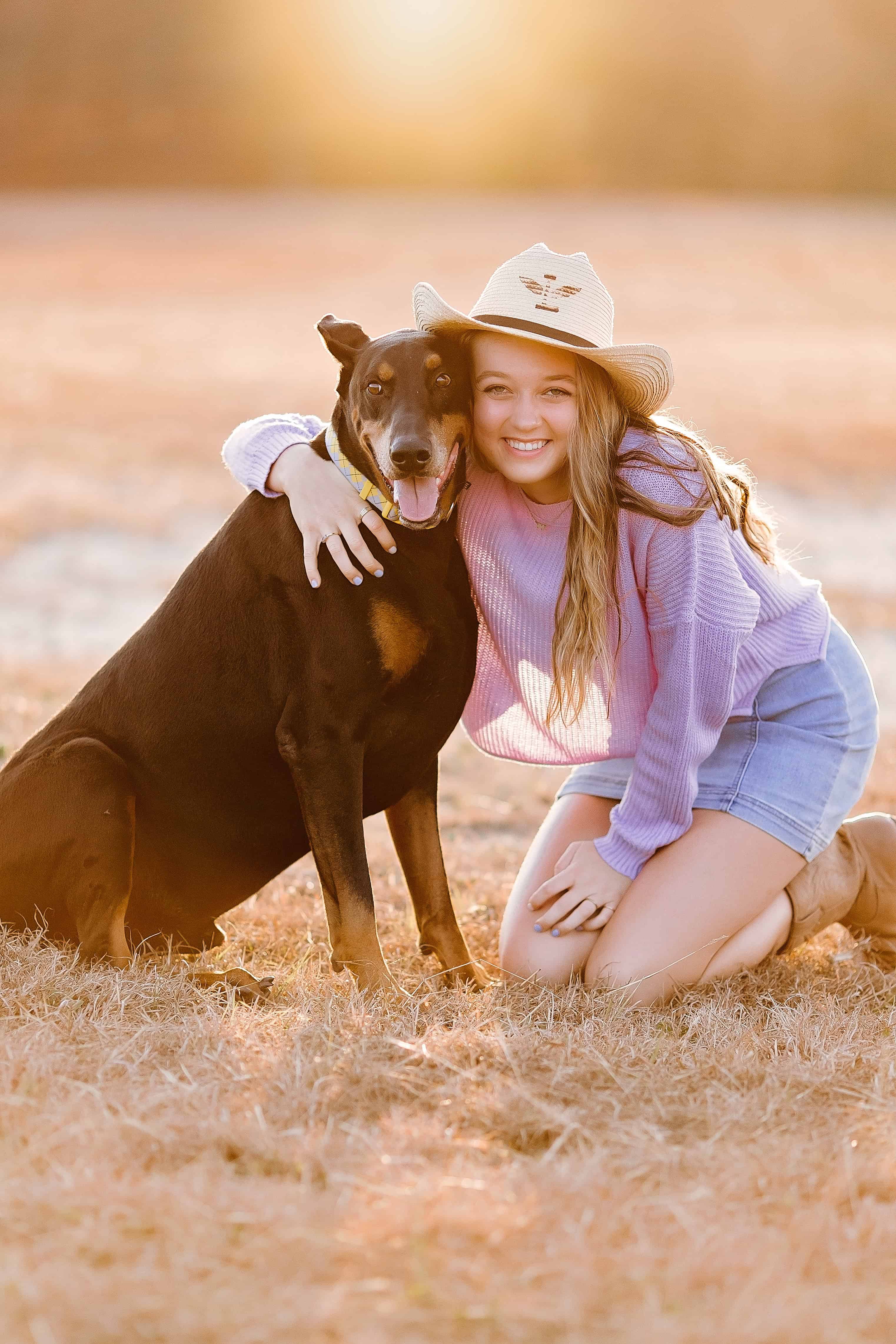 large black rust male doberman in the loving arms of his teenage owner