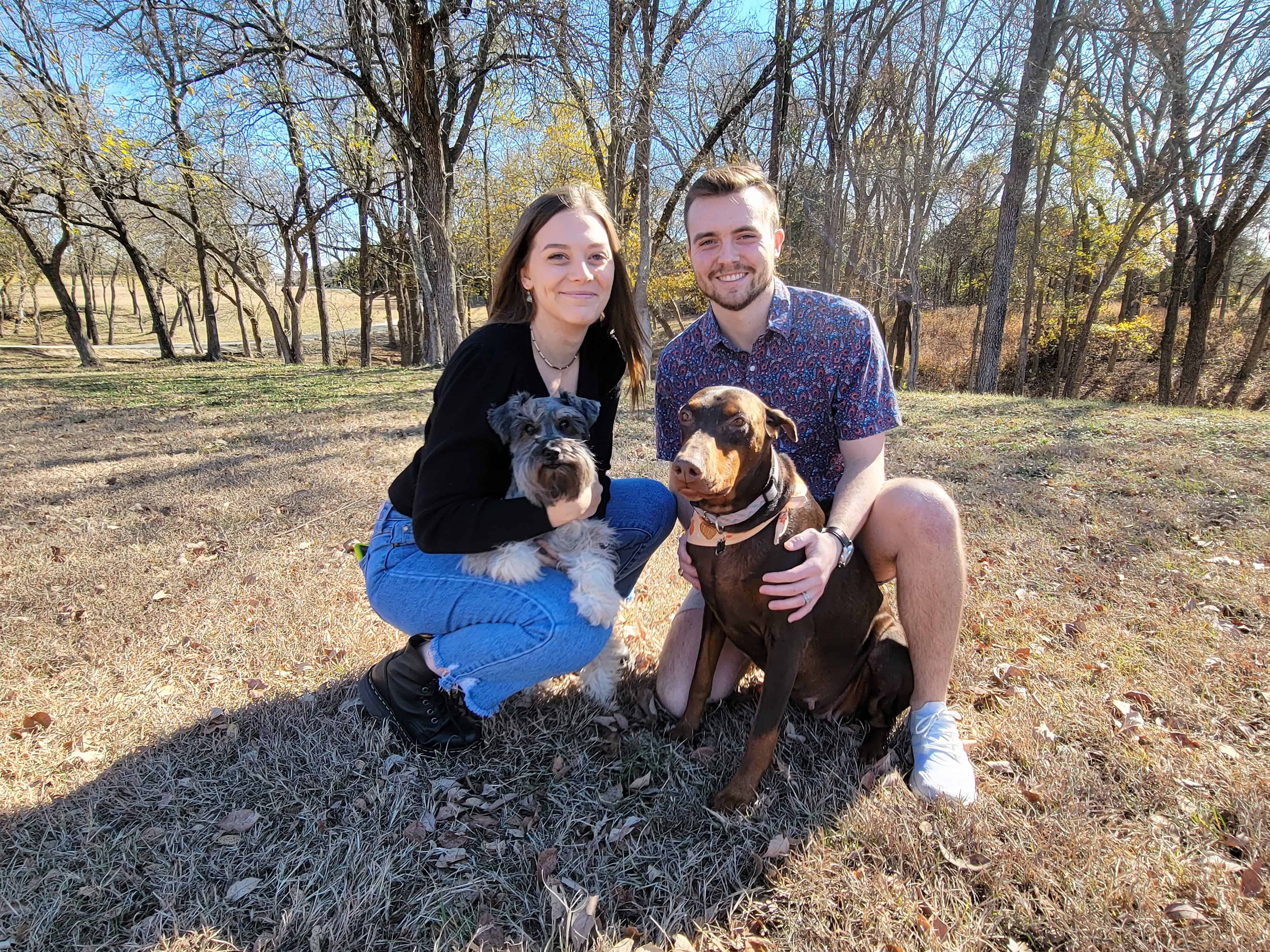 young Garrett with their canine babies Roscoe a Schnauzer and Blue a red rust female Doberman